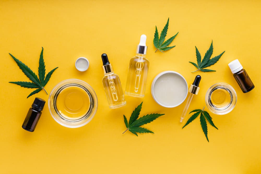 various cannabis products on a bright yellow background