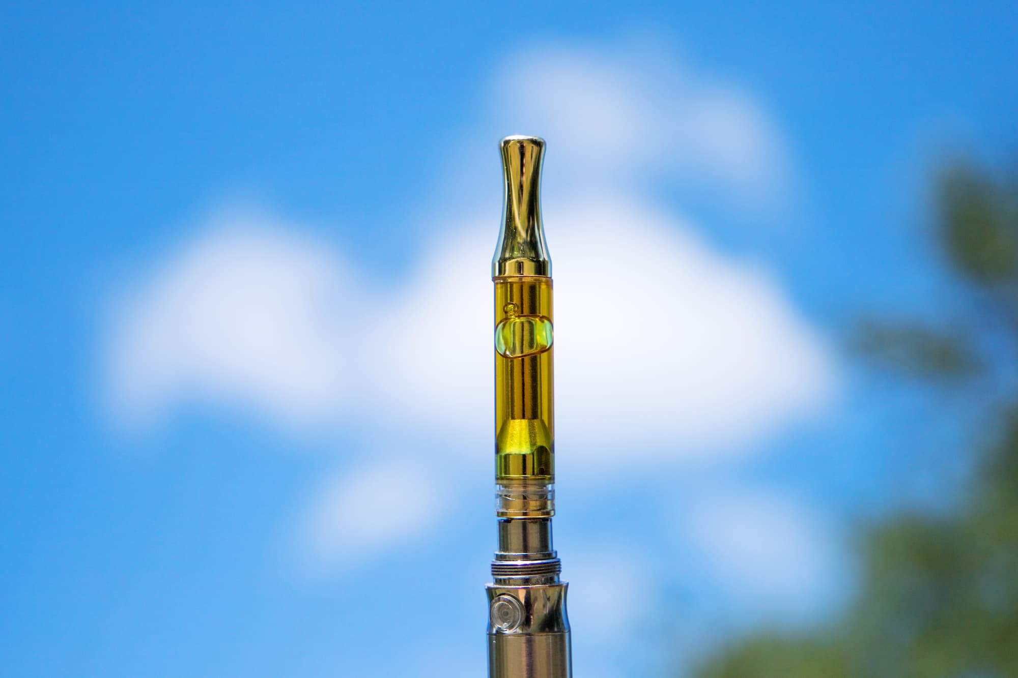 close up image of vape pen with sky in background